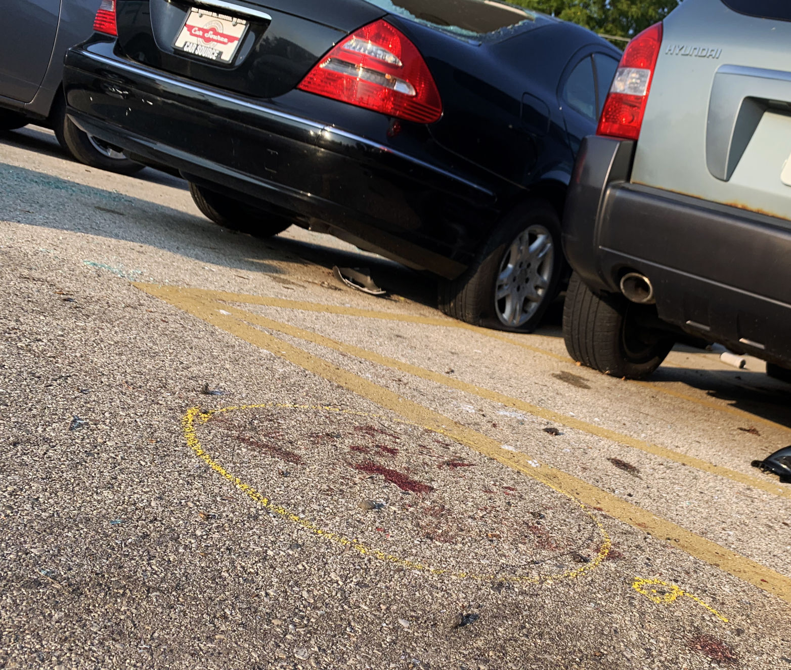 Blood marks and police investigator's marking on the parking lot of Car Source, 6226 Sheridan Road, are shown here, near where Joseph Rosenbaum was shot and killed Aug. 25.